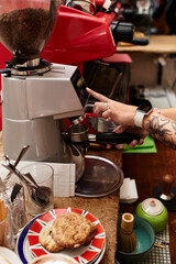 Young woman enjoying café culture while preparing a delightful coffee drink