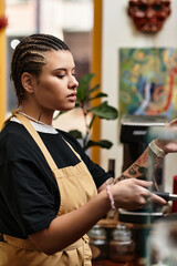 Engaging barista creates coffee magic in a vibrant cafe space filled with personality