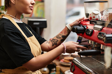 Young woman preparing coffee in a vibrant cafe filled with charm and personality