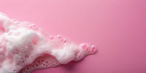 Fototapeta premium Clean, fresh skincare. Pastel pink backdrop showcases fluffy white soap foam; ample copy space. Top view.