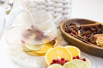Cranberry, lemon and lime tea with cinnamon sticks. An alternative medicine for colds and flu
