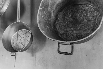 Kitchen utensils hanging on a wall in a rustic environment during daytime