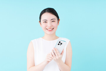 スマホでサロン予約をする若い女性