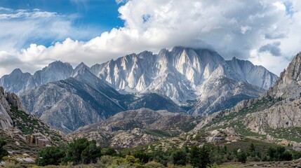 Fototapeta premium Majestic mountain landscape under dramatic clouds with lush greenery in the foreground