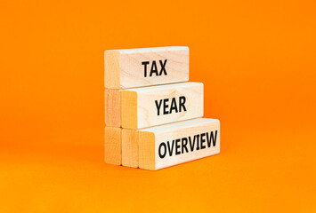 Tax year overview symbol. Concept words Tax year overview on beautiful wooden blocks. Beautiful orange table orange background. Business tax year overview concept. Copy space.