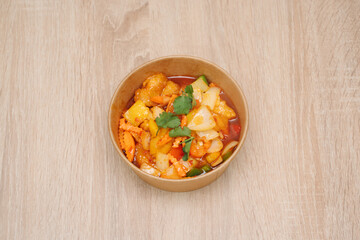 4 flavors fish dish in paper takeout container. Delicious freshly prepared meal, perfect for menus, restaurants, or food delivery concepts.