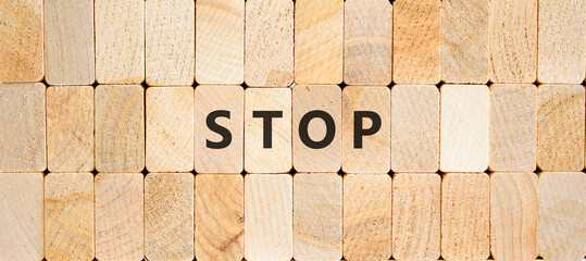 Stop symbol. Concept word Stop on beautiful wooden blocks. Beautiful wooden blocks background....