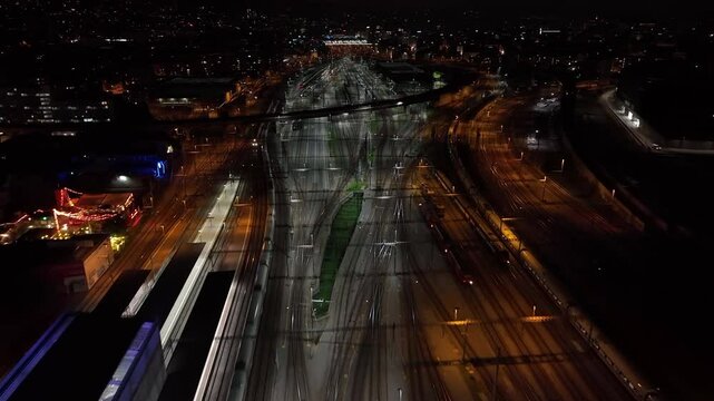 night time illuminated flight over zurich traffic street road bridge railways aerial topdown panorama 4k switzerland  