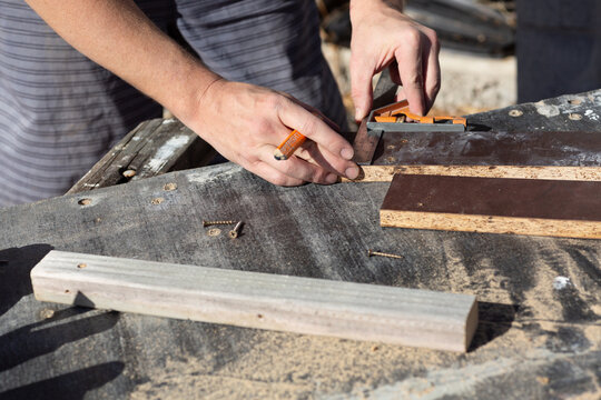 Hands of man measuring DIY project