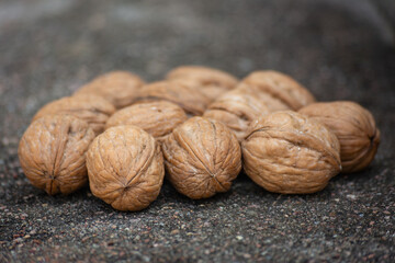 Dry walnuts on cement background