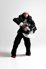 Full length photo o f young business lady, stand confidently with briefcase and looking upward against white studio background. Concept of business, self-expression, motivation. Ad