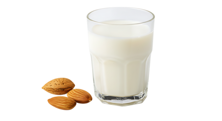 A glass filled with almond milk beside almonds on a black background in a studio setting view