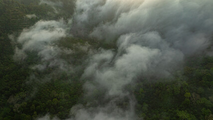 Fototapeta premium landscape, with layers of fog and vibrant colors painting the horizon. The serene atmosphere and natural beauty