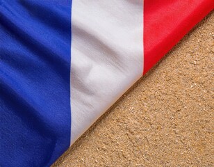 Fototapeta premium French flag draped on sandy beach representing france's coastal charm