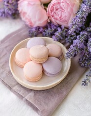 Pastel macarons and fresh peonies on linen with lavender
