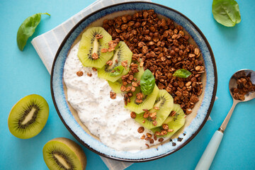 Chocolate granola with fresh fruits, yogurt and chia seeds on the table