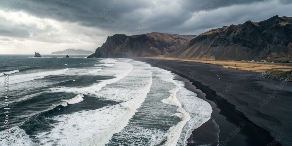 Poster Moody coastline with dark sands and crashing waves under a cloudy sky.