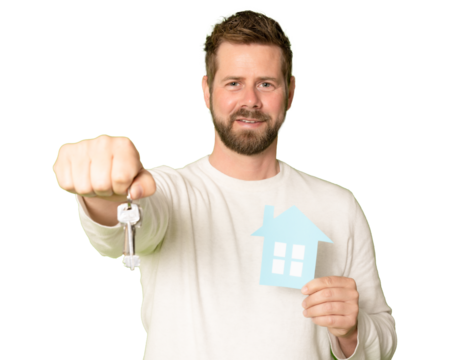 Young happy man holding a key and a model house isolated on transparent background. PNG transparent.