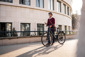 Businessman Commutes by Bike Using Smartphone in Urban Environment