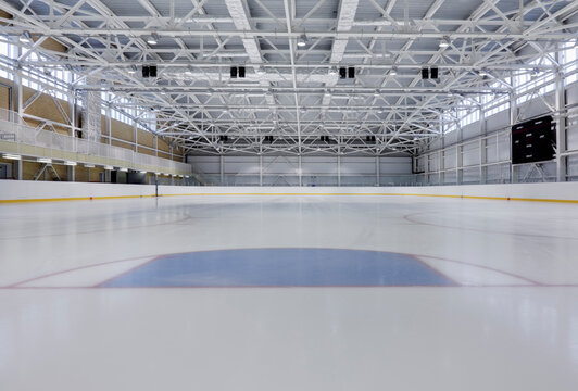 Interior view of an ice rink with ice hockey markings.