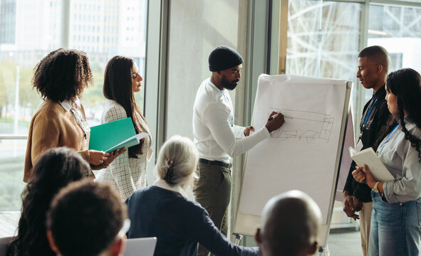 Diverse team of colleagues collaborating on a project in a modern corporate business setting