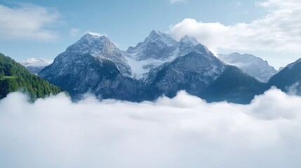 Obraz premium Majestic alpine peaks pierce a sea of clouds. Vast, snow-capped mountains rise above a valley blanketed in a thick layer of fog. 