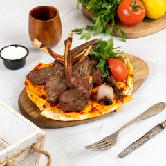 Delicious Grilled Lamb Chops with Vegetables on a Wooden Board