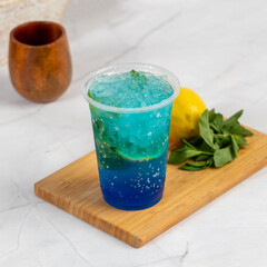 Refreshing blue lagoon mojtio cocktail with mint, lemon, and ice