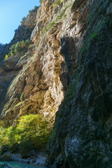 Scenic Chegem waterfalls, cascading down rugged, moss-covered cliff into tranquil pool below. Chegem River flow between steep cliffs with grottoes created by nature. Kabardino-Balkaria. Chegem Gorge