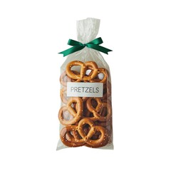 A clear plastic bag filled with delicious pretzels, tied with a green ribbon