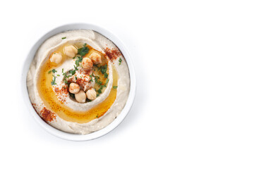 Chickpea hummus with olive oil, parsley and paprika in bowl isolated on white background. Top view. Copy space