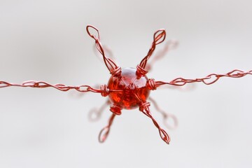Red glossy sculpture with spread arms and crucifix like form made of fragmented material suspended in space representing emotional sacrifice digital martyr and broken symbolism
