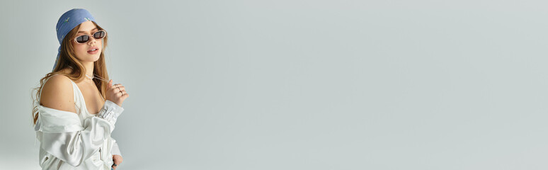 Stylish young woman showcases vibrant spring fashion in modern studio setting