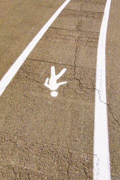 A pedestrian only lane, a dedicated walking lane on a tarmac pathway, management of transport and people.
