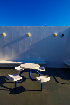A ferry deck, fixed seating and a round table.