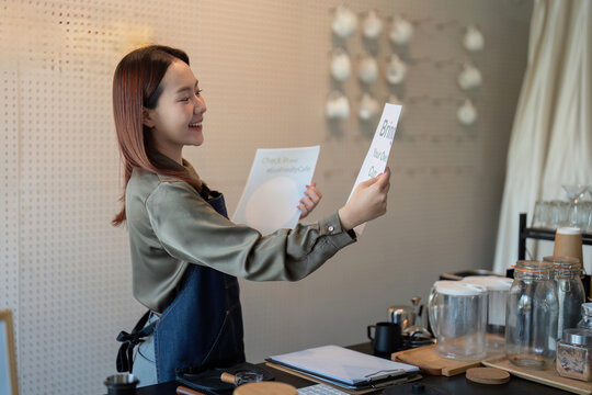 Eco-Friendly Initiatives and Customer Interaction. A barista enthusiastically displaying a message about sustainable practices.
