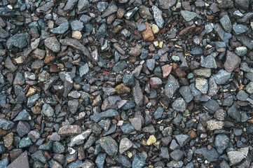 Gray small rocks ground texture. black small road stone background.