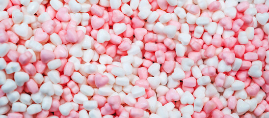 Panoramic background of sweet pink and white candy hearts
