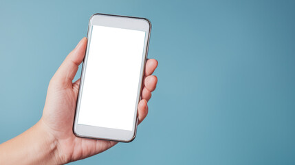 A hand holding a smartphone with a blank screen against a light blue background.