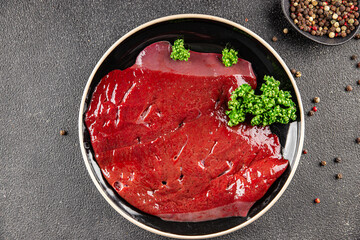 Raw liver beef veal meat steak liver grill appetizer vegetables dish fresh delicious gourmet food background on the table rustic food top view copy space keto and paleo diet