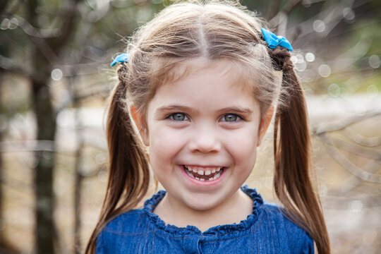 Happy little girl with gap in teeth from first lost tooth