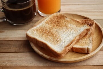 Breakfast of toast bread and black coffee orange juice