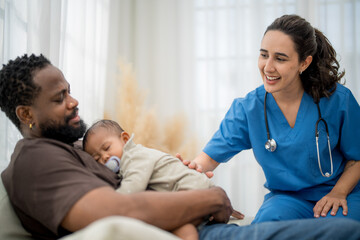 Fototapeta premium Caring interaction between healthcare professional and father with sleeping baby at a cozy home setting