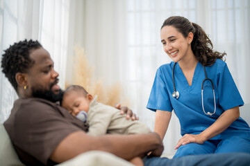 Fototapeta premium Caring pediatric nurse comforts father with sleeping baby during a medical consultation in a cozy setting