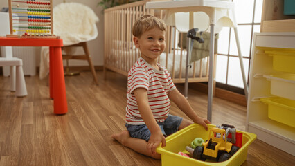 Blond toddler boy playing happily with toys in a kindergarten setting with colorful furniture, showcasing a bright, joyful childhood indoors