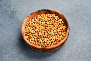 Dry soybeans in a wooden bowl. Free space for text.