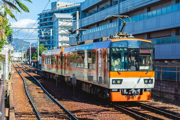Local train arrive to railway station platform in Kyoto Japan. Train transportation concept.