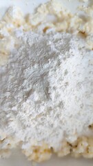 Mixing flour with other ingredients for baking preparation in a bright kitchen