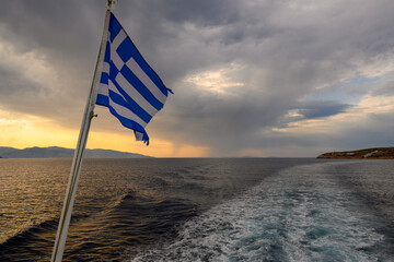 The ferry with Greek flag. Cyclades Islands cruise in the Aegean Sea. Greece