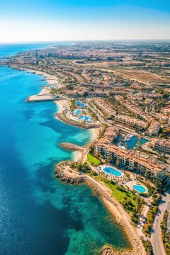 Aerial view of La Zenia coastline in Orihuela with turquoise sea, beaches, resorts and sunny summer landscape